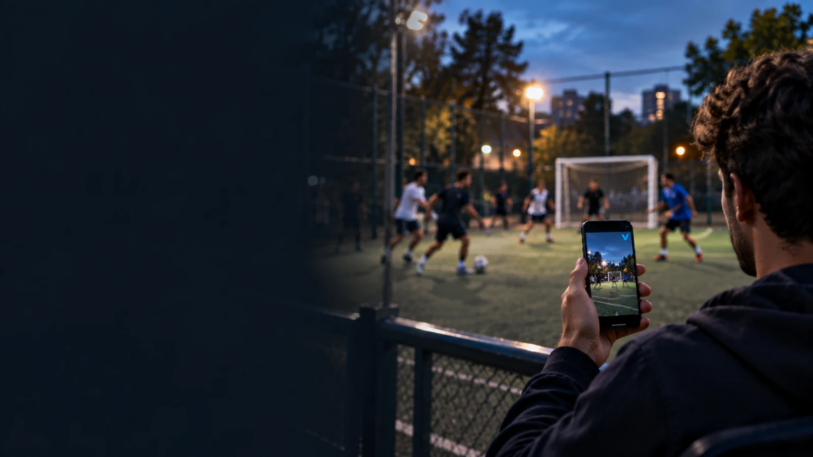 A fan following a floodlit evening football game on the VISU app