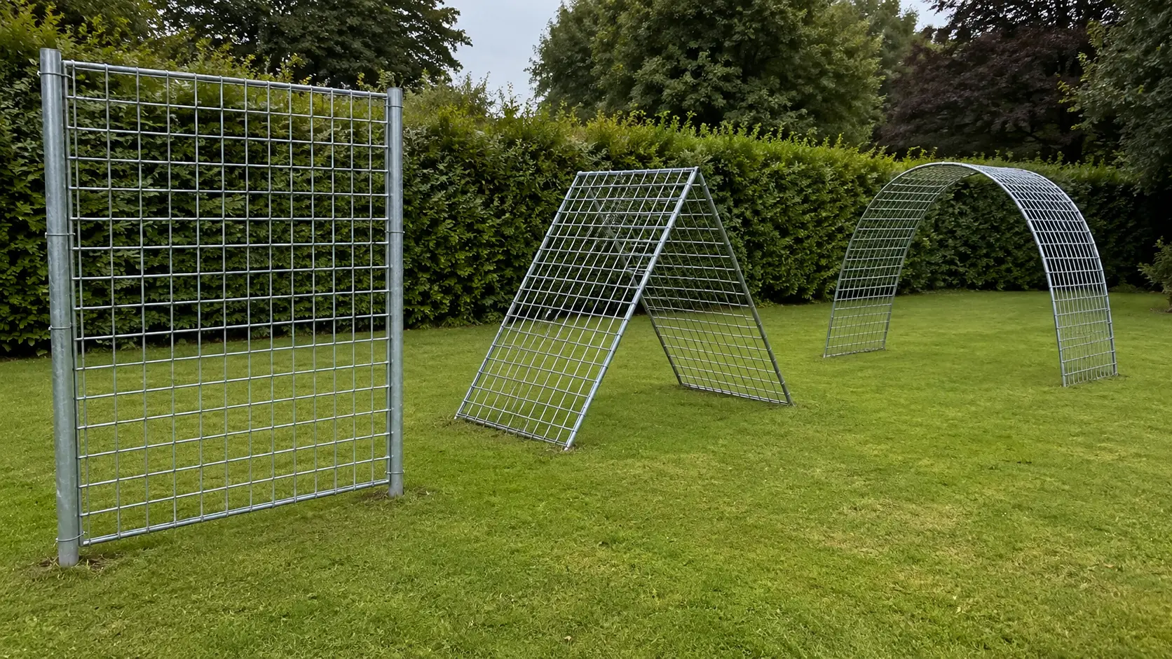 Three cattle panel trellis forms side by side in a garden: one flat panel upright against posts, one pair leaned into an A-frame, and one bent into an arch spanning two beds